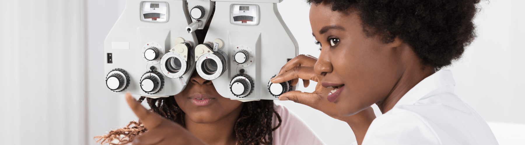 Female Optometrist doing an eye exam on young female patient