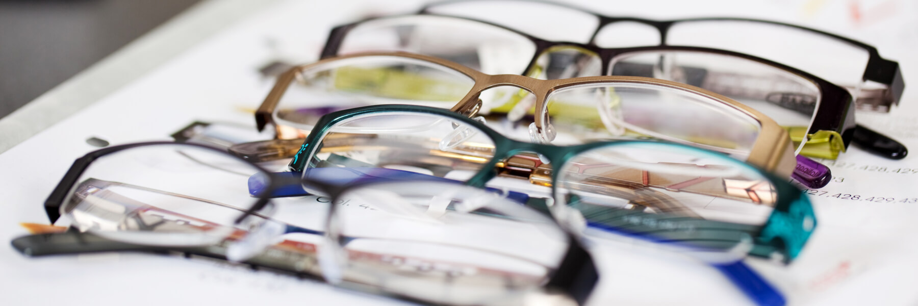 detail view of various eyeglasses lying on a tray, fashion and eyewear, glasses