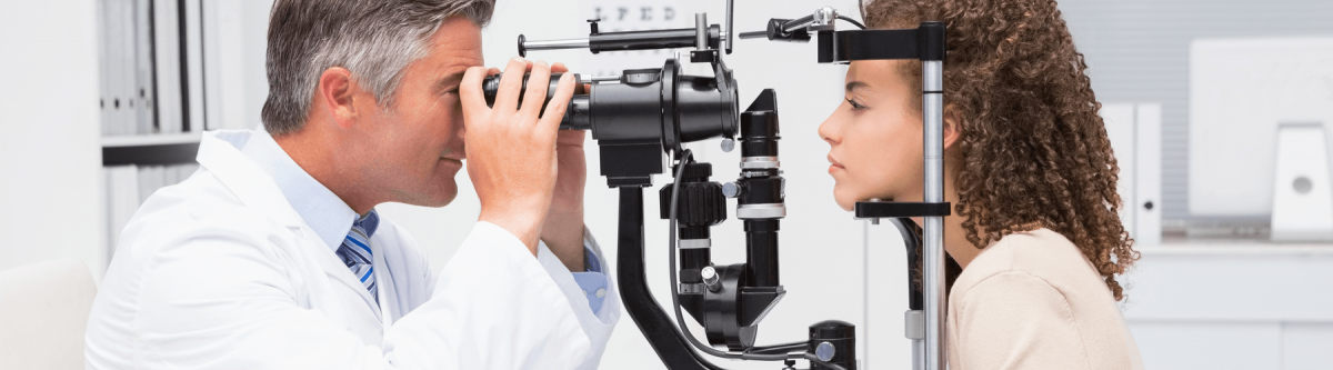 Woman doing eye exam with optometrist in medical office