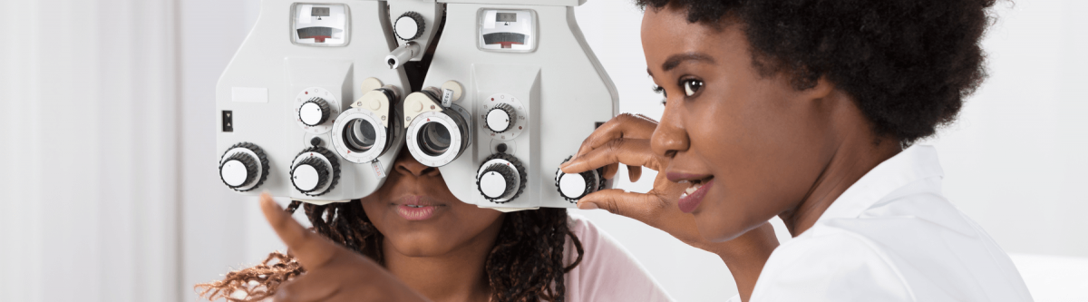 Female Optometrist doing an eye exam on young female patient