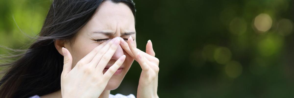 woman in dry air outdoors rubbing dry eyes