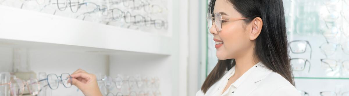 ophthalmologist holding tablet and eyeglasses in optical center