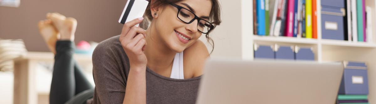 Happy woman wearing glasses doing online shopping at home