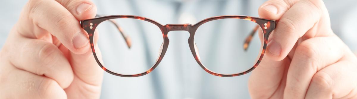 optometrist holding repaired glasses, warranty concept