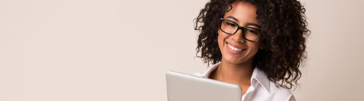 young african american female wearing glasses, on tablet, patient resources concept